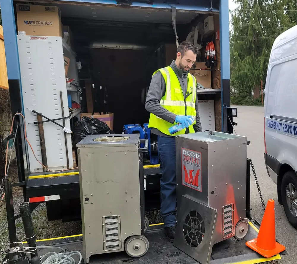 AWDR technician cleaning restoration equipment before transport