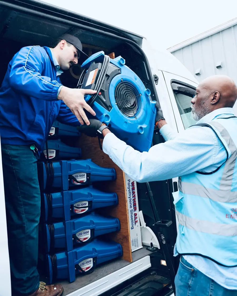 AWDR crew unloading air-moving equipment from a service van