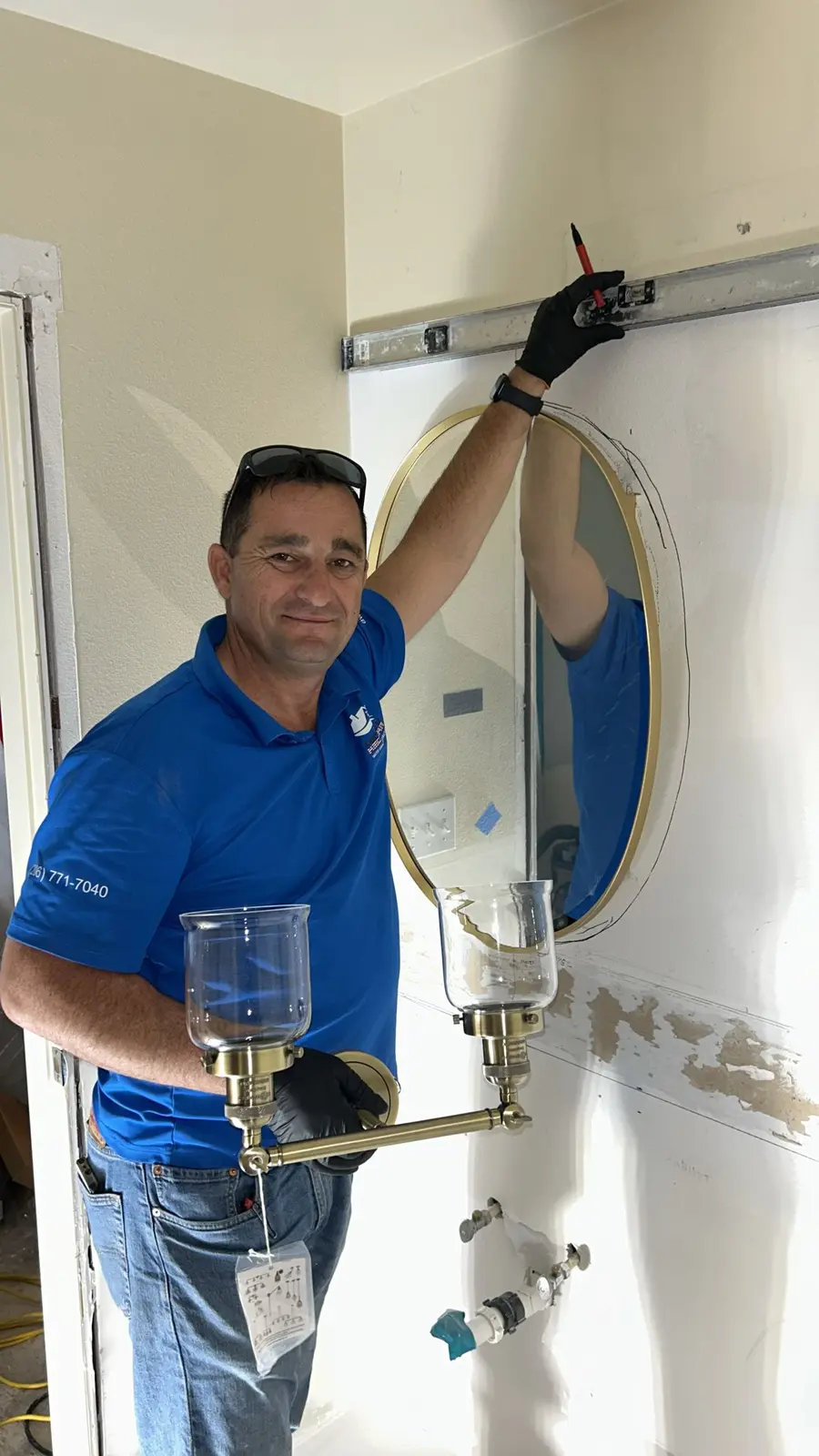 AWDR technician installing a bathroom medicine cabinet during reconstruction