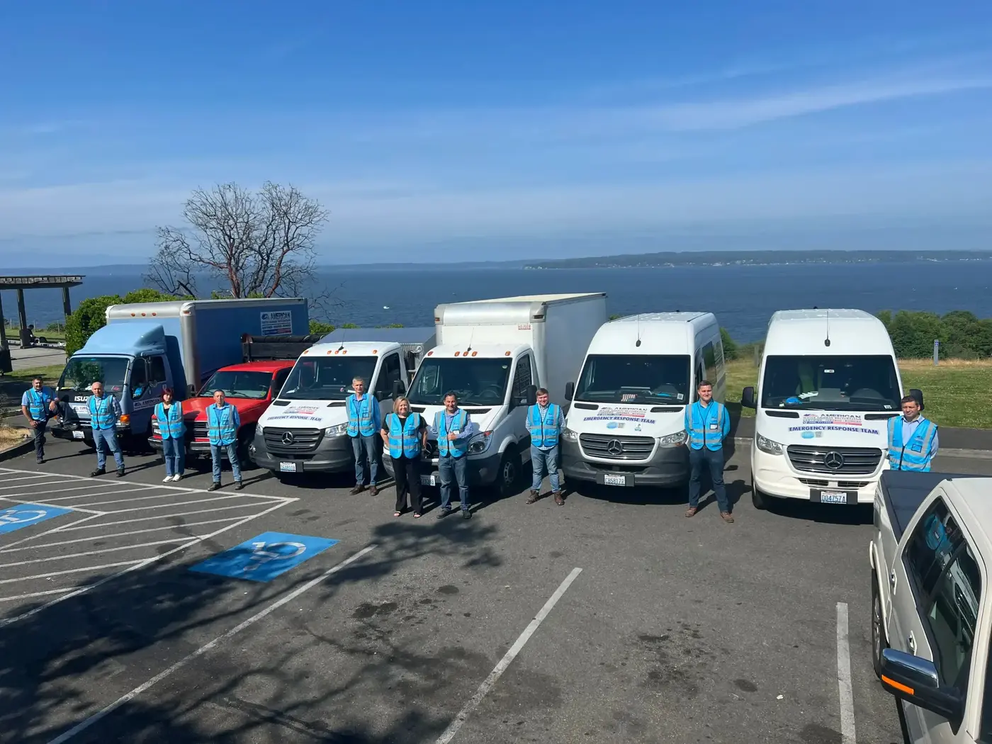 AWDR restoration team standing in front of company service vehicles