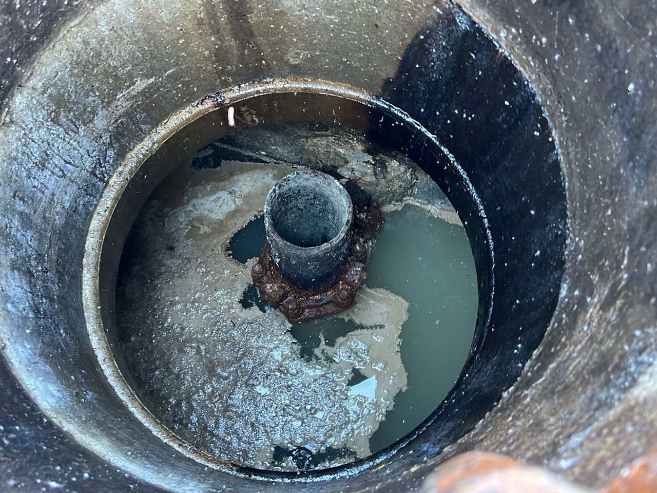 Close-up of liquid and a pipe inside an open access area